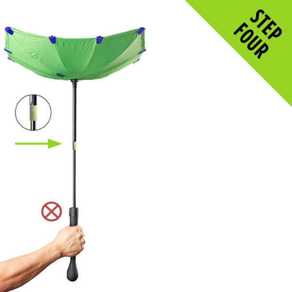 Still holding the handle, use your other hand to grip the metal ring half way up the shaft.
